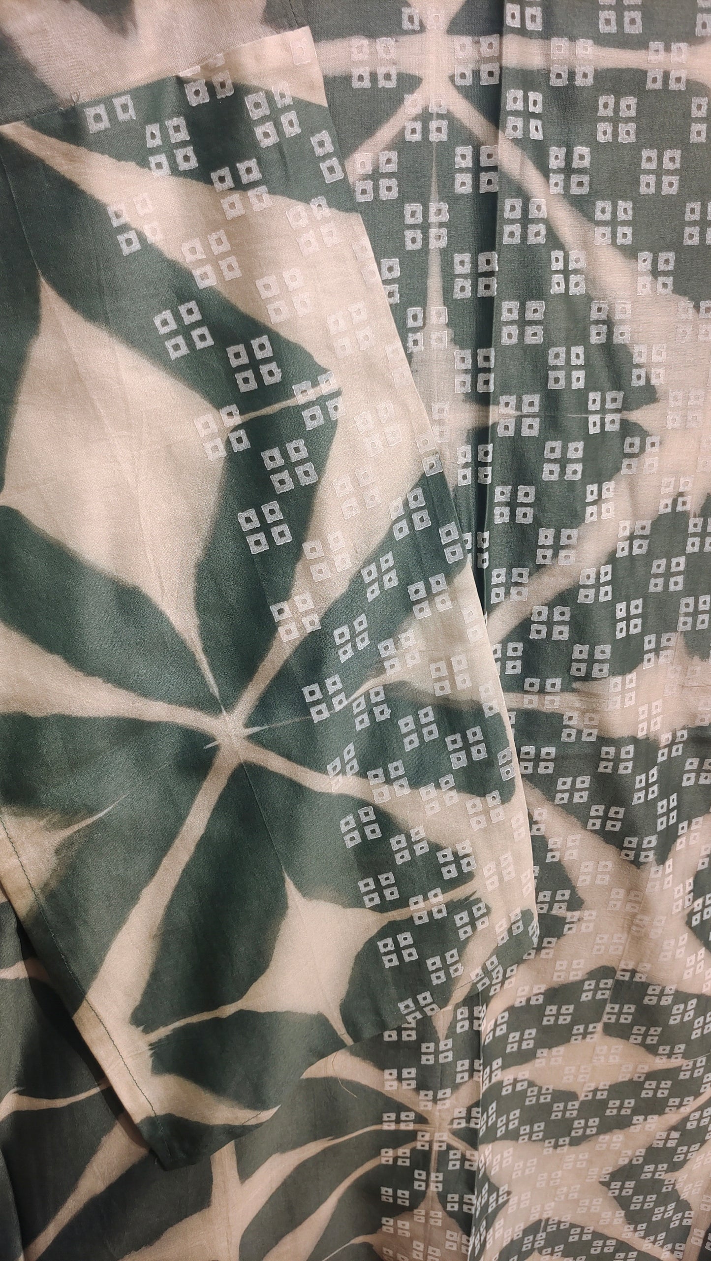 Close-up of fabric with grey pattern on a beige background