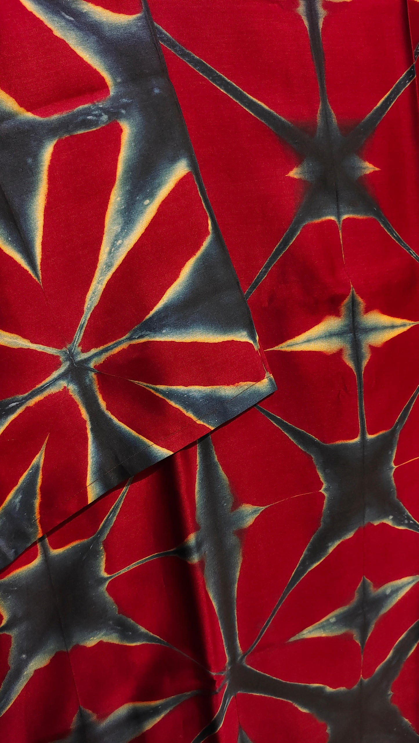 Red fabric with black starburst pattern