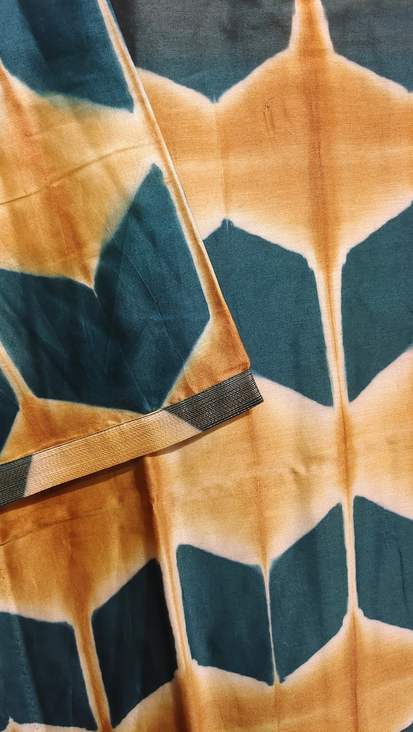 Close-up of a fabric with green and brown geometric pattern