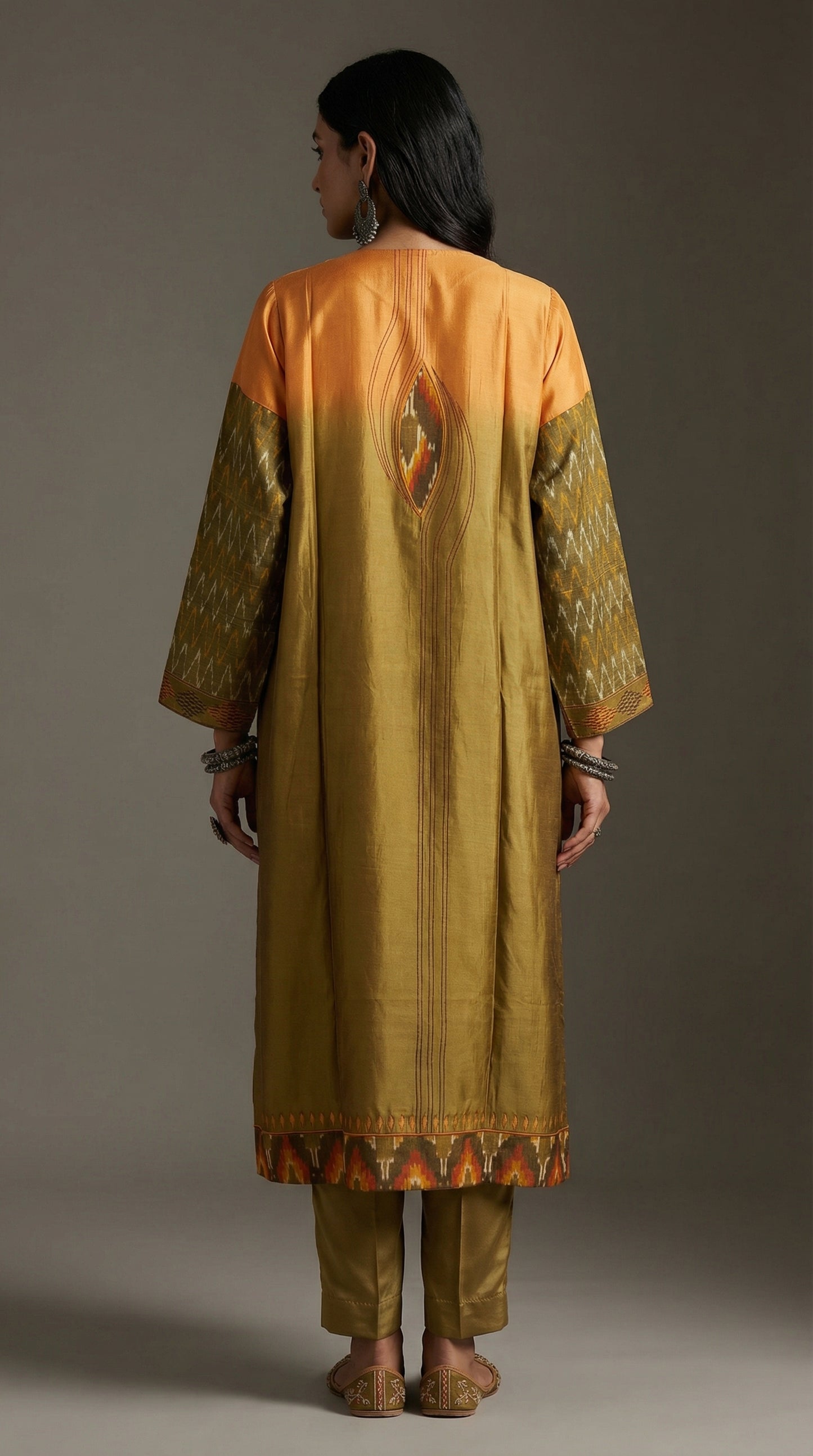 Person wearing a traditional kurta with a gradient design on a plain background