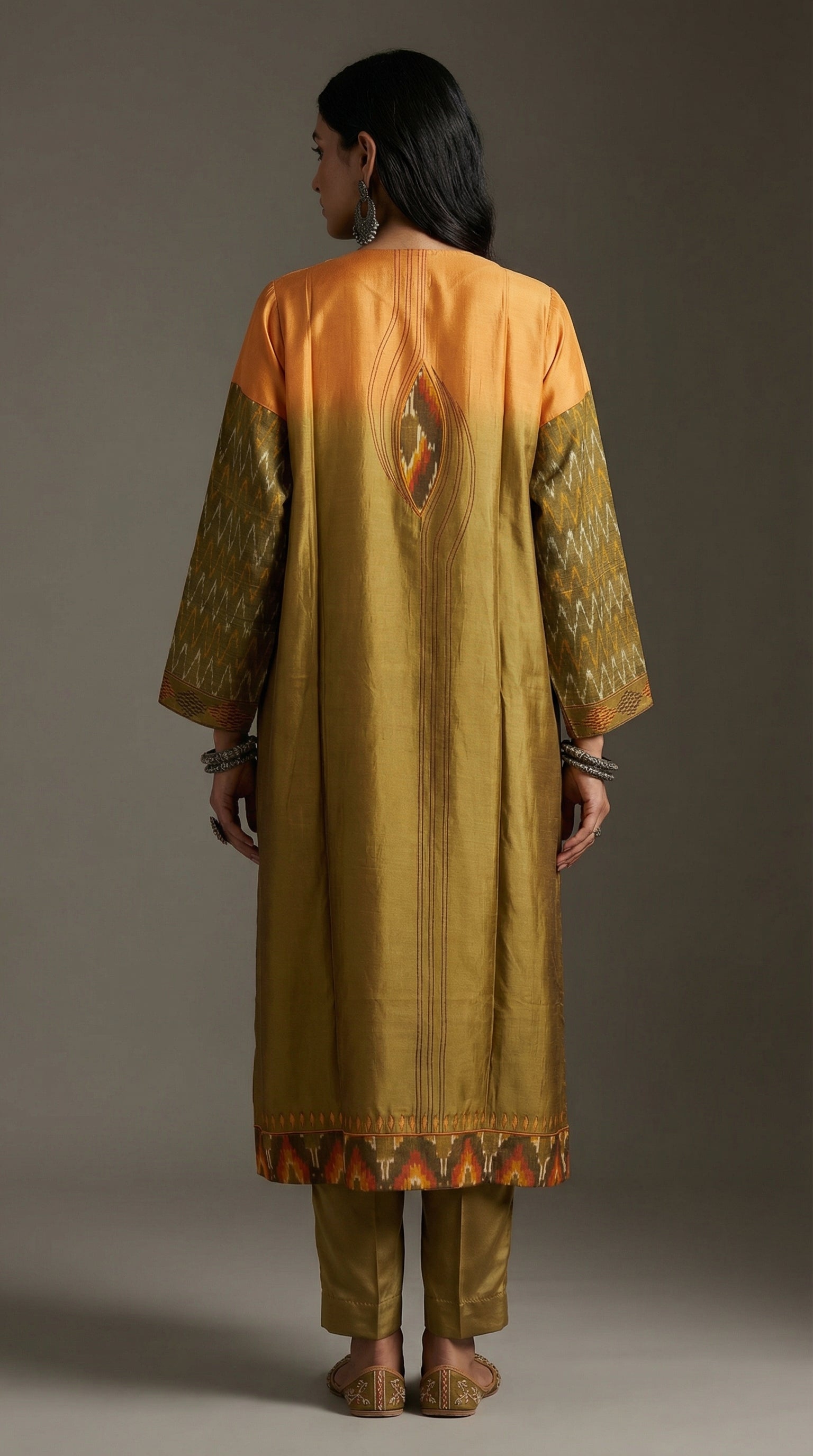 Person wearing a traditional kurta with a gradient design on a plain background