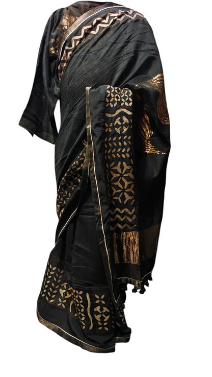 Black saree with gold patterns on a white background