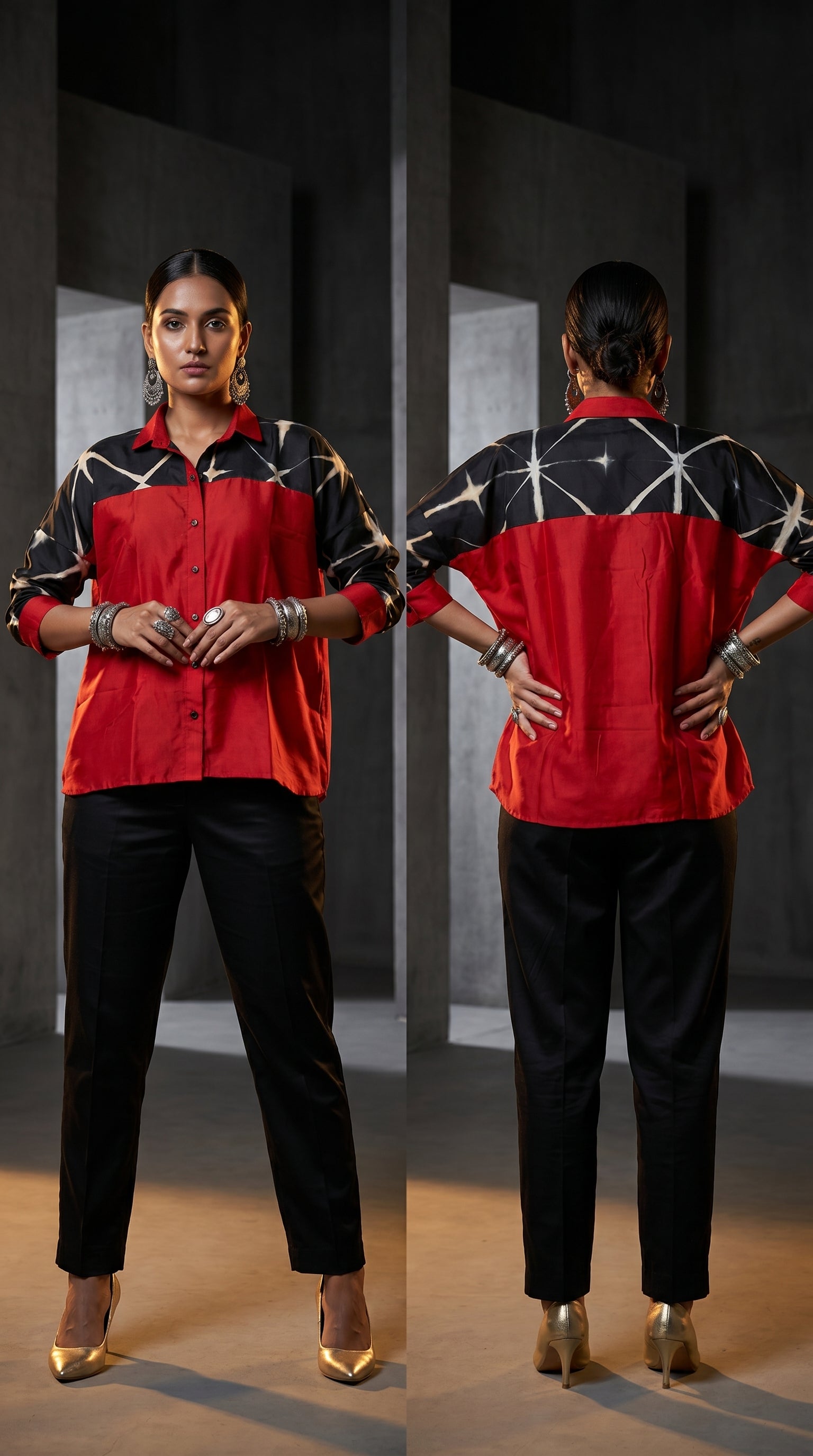Woman wearing a red and black patterned shirt with black pants, standing in front of a mirror.