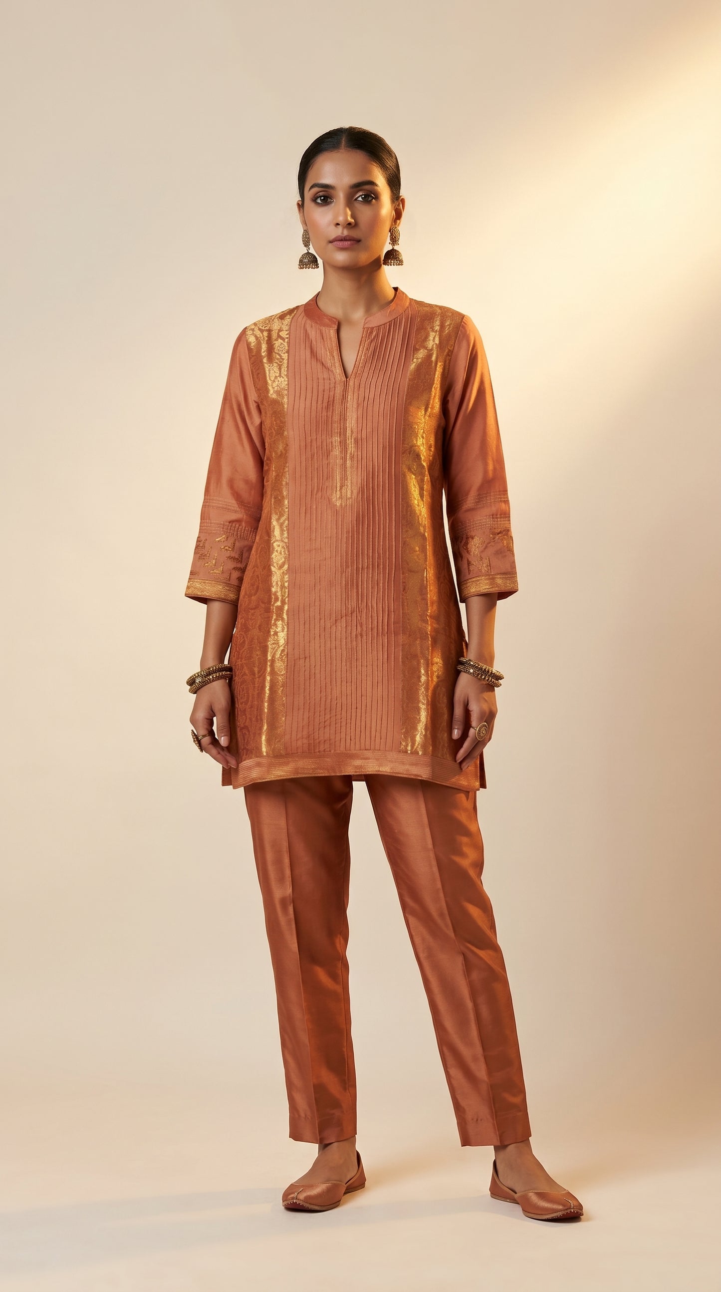 Woman wearing a brown traditional outfit with a plain background