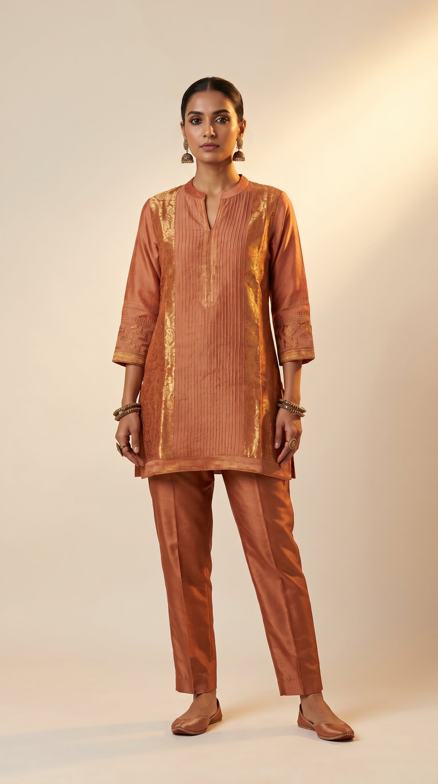 Woman wearing a brown traditional outfit with a plain background