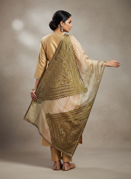 Woman wearing a beige traditional kurta with a green embroidered dupatta against a neutral background