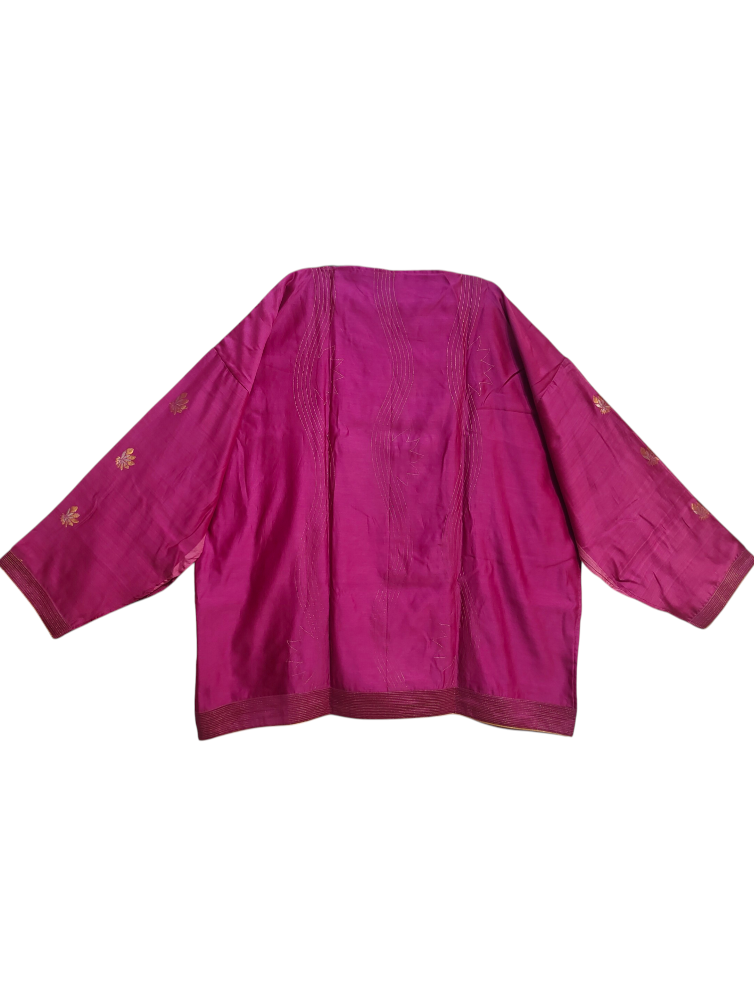 Pink fabric with gold embroidery on a white background
