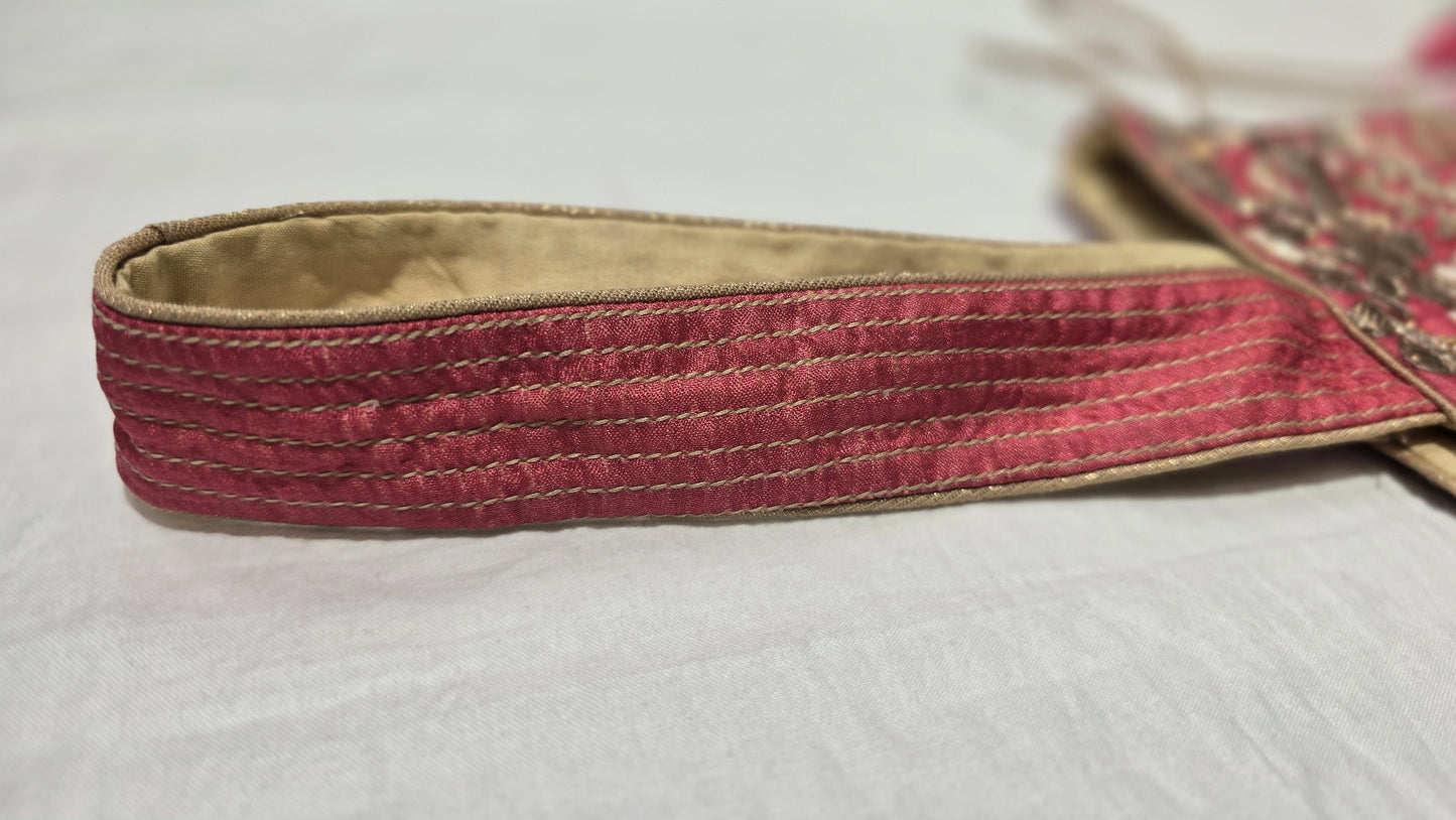 Pink belt with a textured pattern on a white background