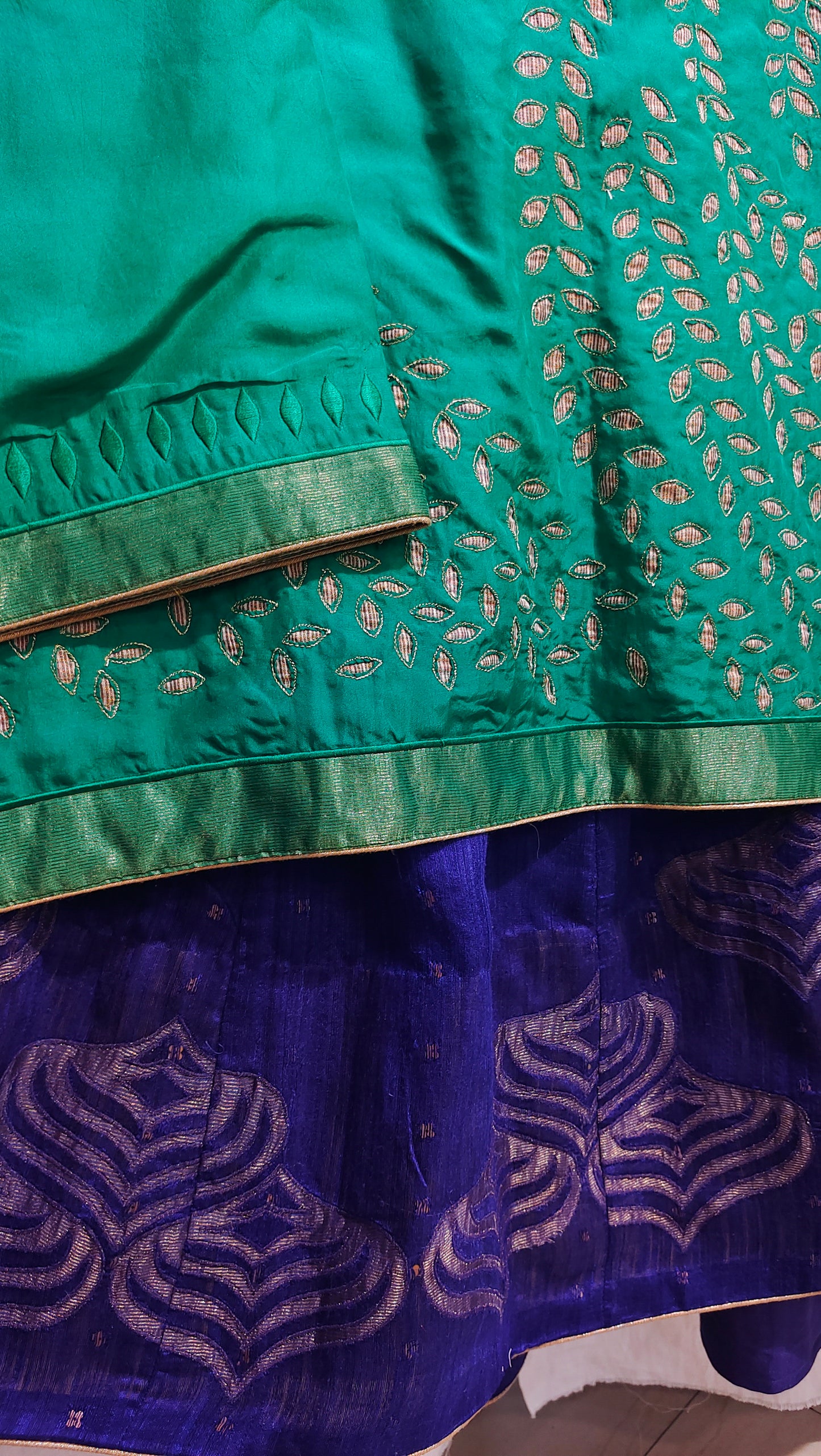 Close-up of green and blue fabric with intricate patterns