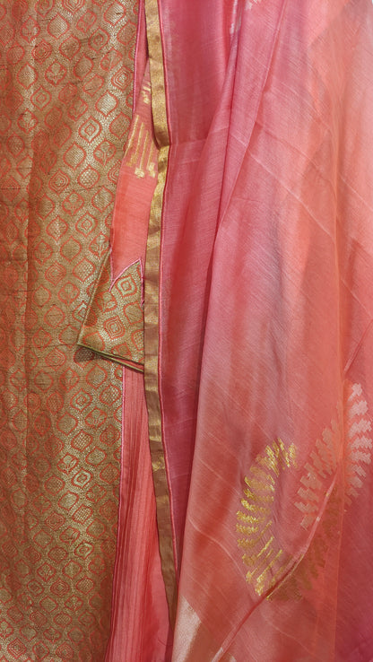 Close-up of a peach suit with gold patterns and border