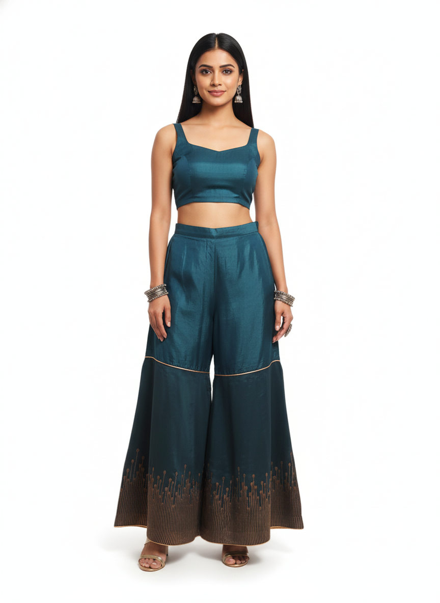 Woman wearing a teal plazzo pant on a white background