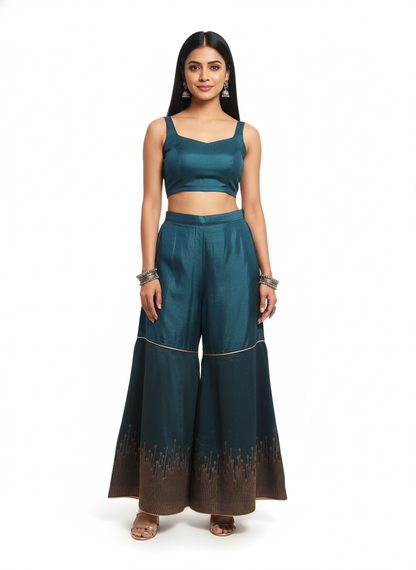 Woman wearing a teal plazzo pant on a white background