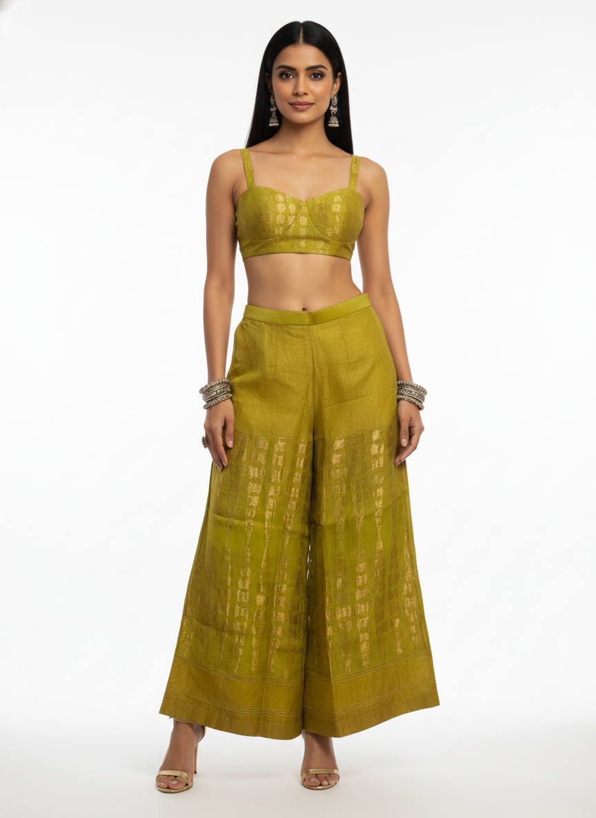 Woman wearing a green traditional plazzo pant with a white background
