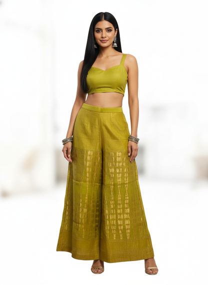 Woman wearing a green plazzo pant with a white background