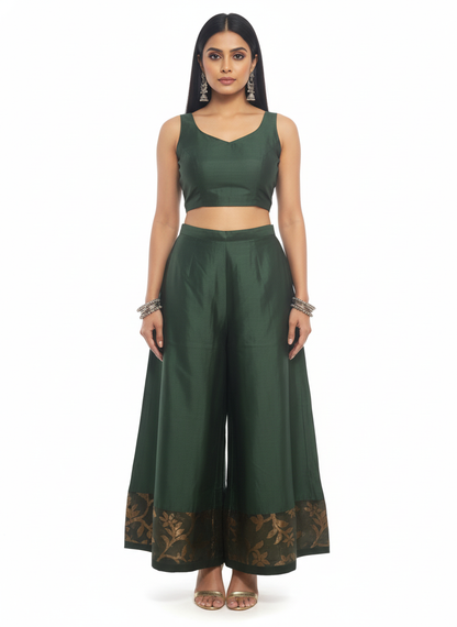 Woman wearing a green outfit with a matching top and plazzo pant on a white background