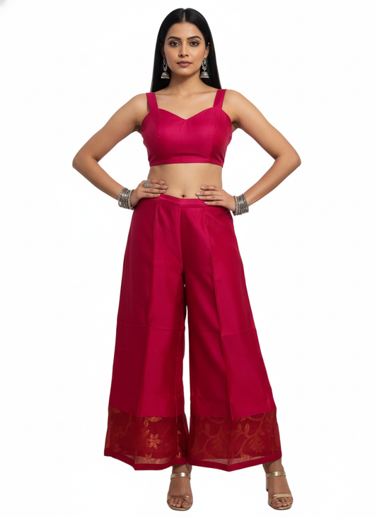 Woman wearing a bright pink traditional plazzo  pant on a white background