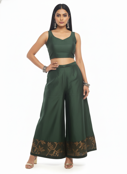 Woman wearing a green plazzo pant a white background