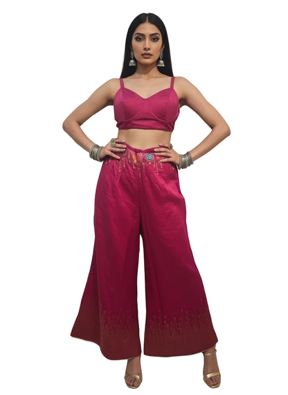 Woman wearing a pink plazzo pant with on a white background