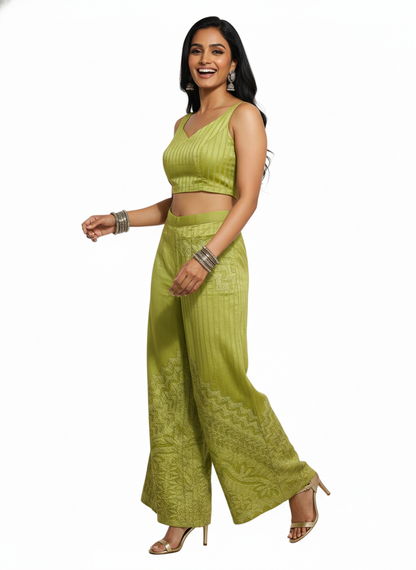 Woman wearing a green traditional plazzo on a white background