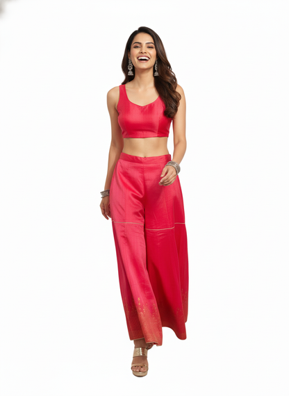 Woman wearing a pink plazzo pant on a white background
