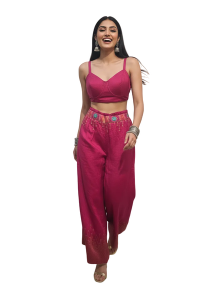 Woman wearing a pink traditional plazzo pant with a white background