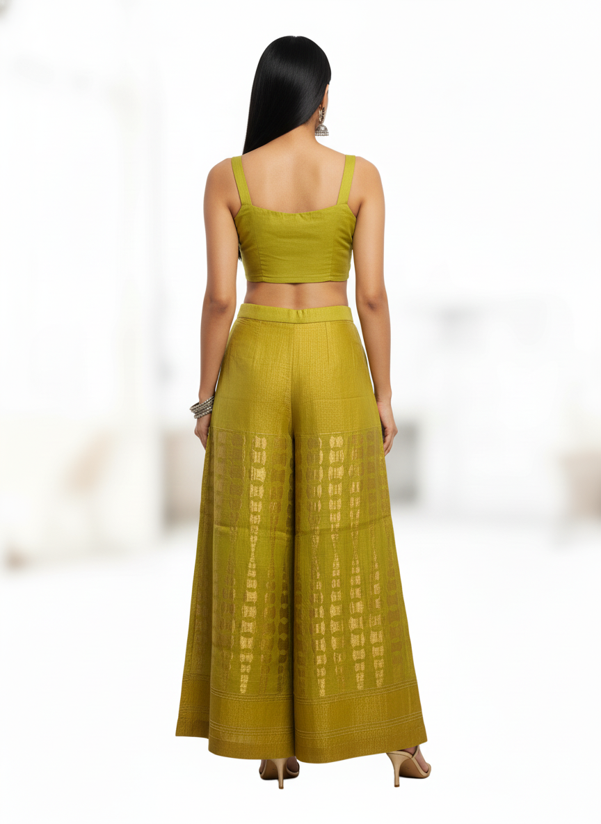 Woman wearing a green plazzo pant with a white background