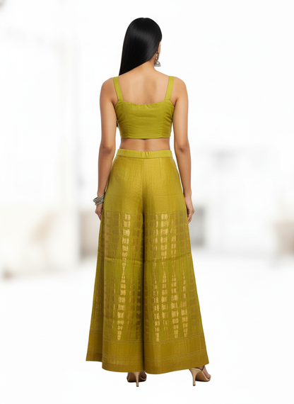 Woman wearing a green plazzo pant with a white background