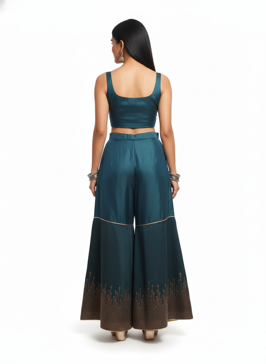 Woman wearing a teal traditional plazzo pant on a white background