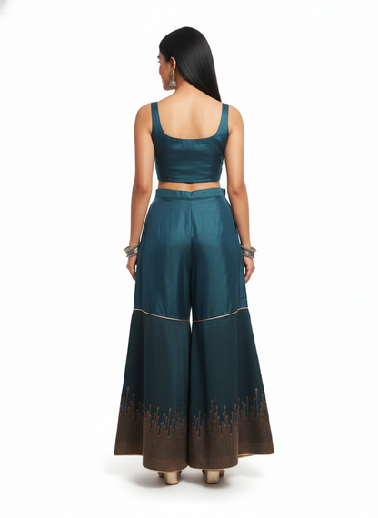 Woman wearing a teal traditional plazzo pant on a white background